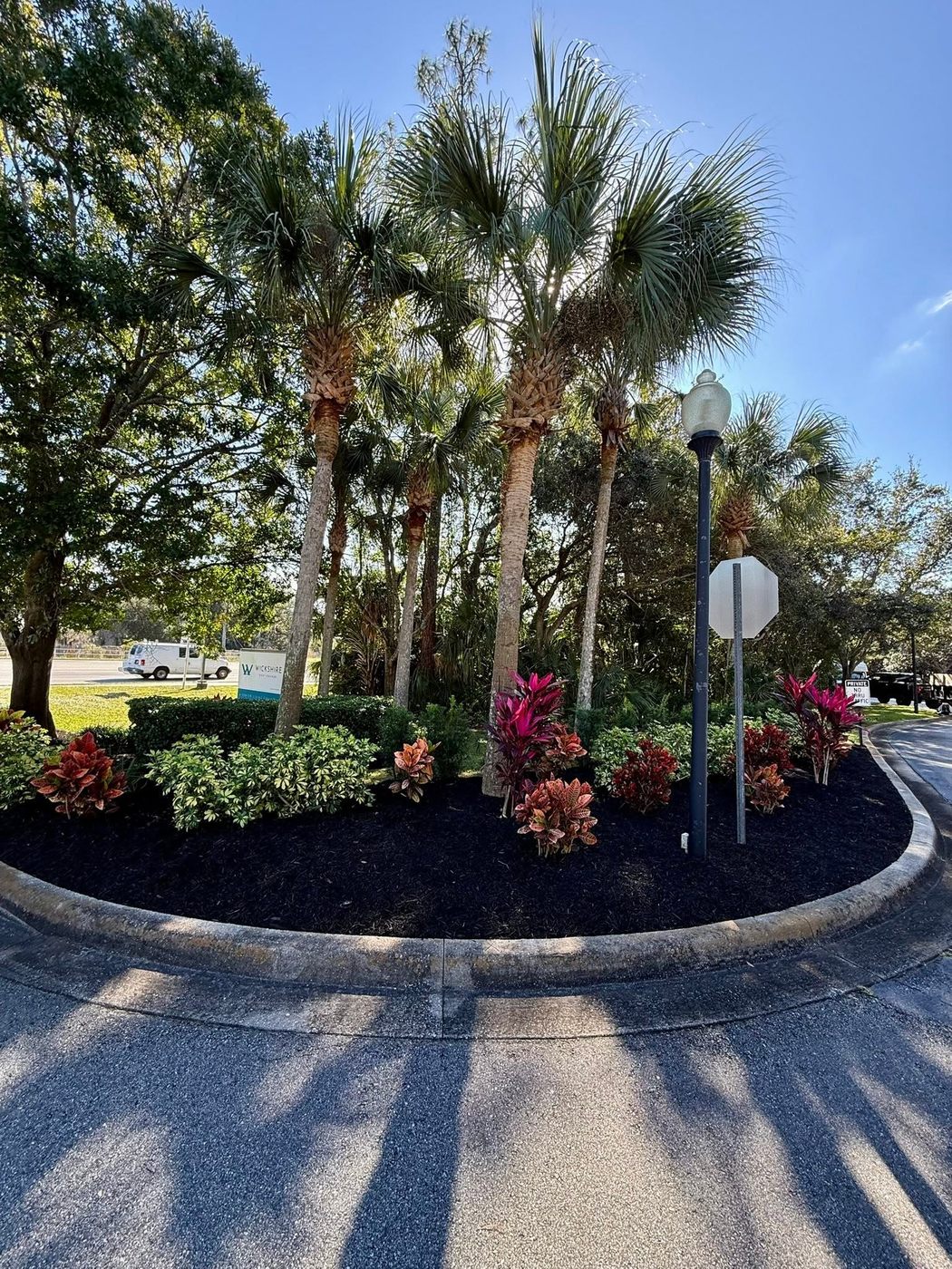 Commercial roundabout landscaping with colorful plantings